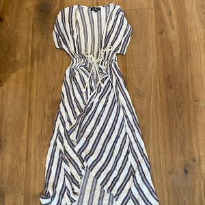 Long white, blue, and cream beach coverup with rope ties lightly warn